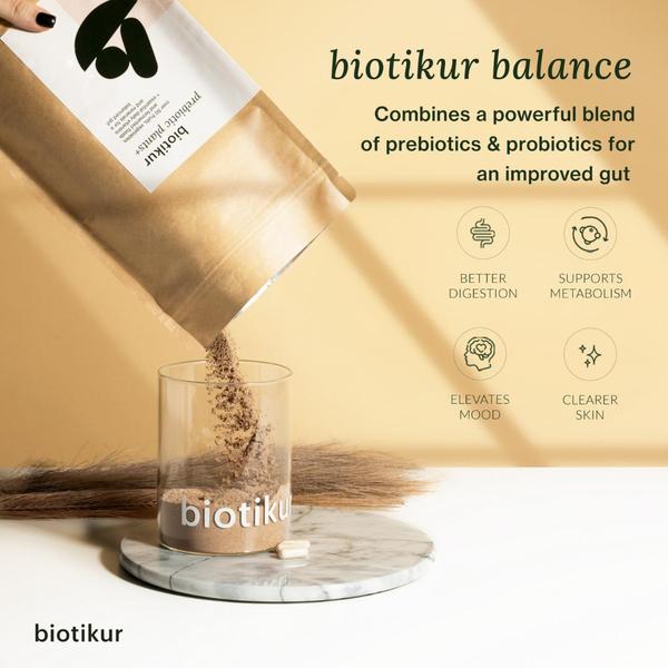 A clean, minimalist product-in-use shot showing a prebiotic powder being poured into a glass, paired with a four-point benefit summary.